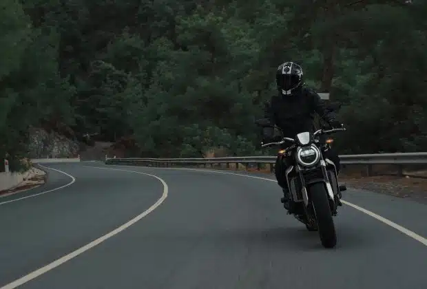 man riding motorcycle on concrete street